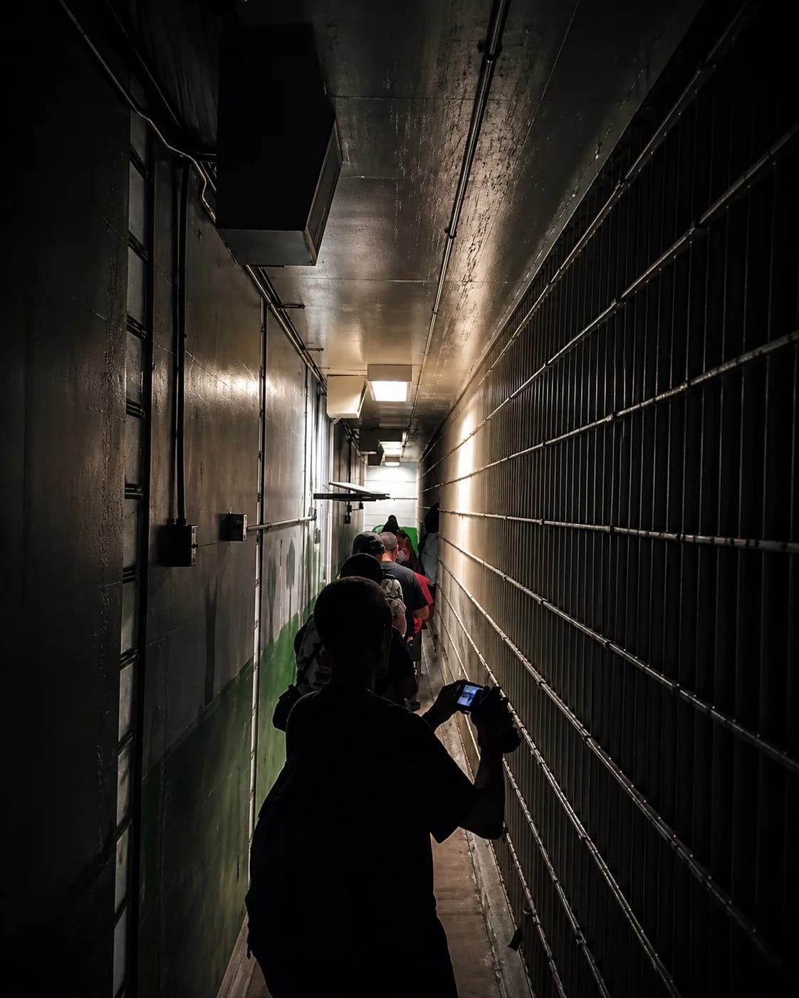 Guests walking the cell-block corridor of the former First Avenue Jail during the Haunted Jails & Ruff Tails ghost hunt