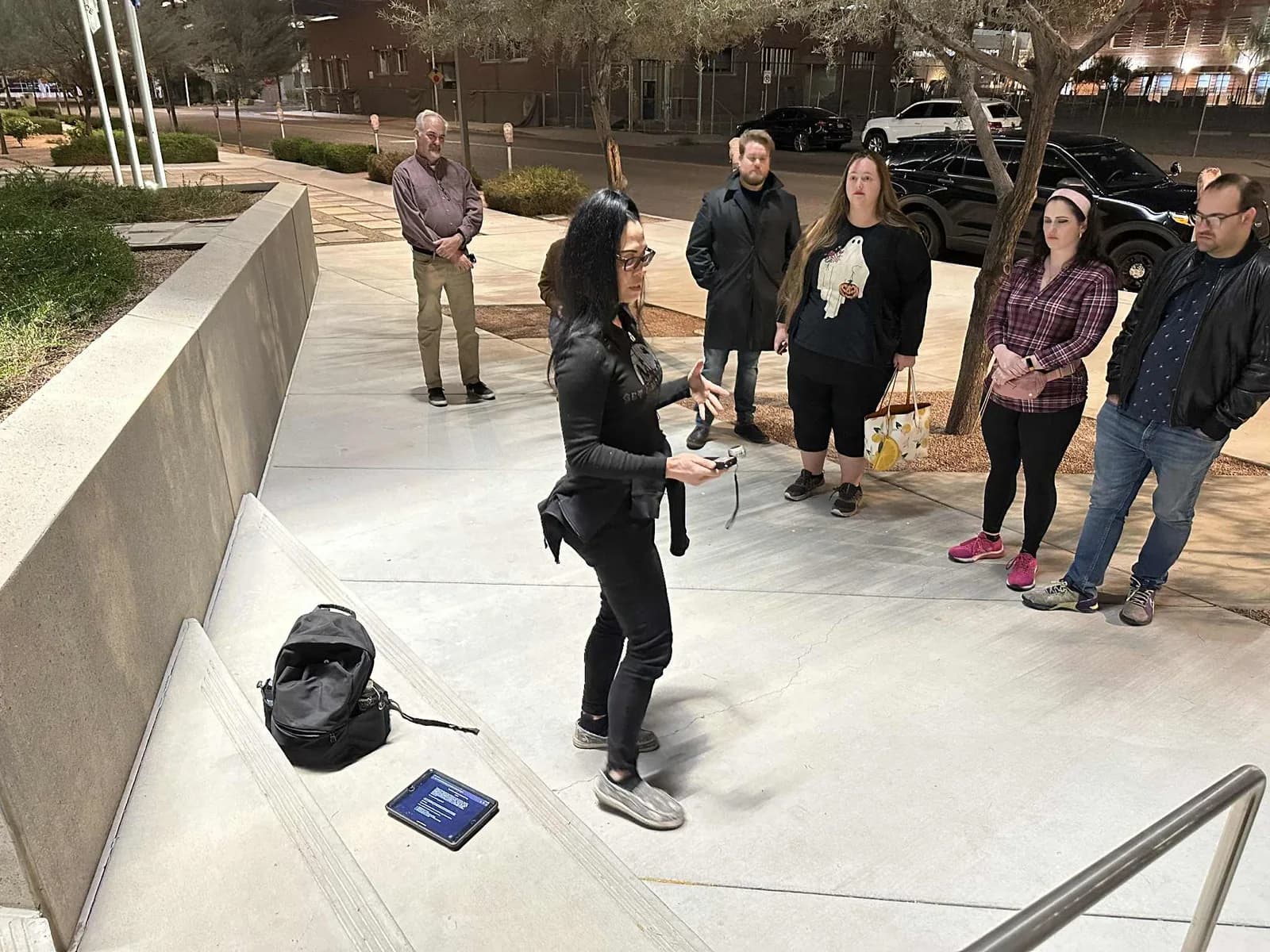 Guests watching an outdoor ghost-hunting demonstration